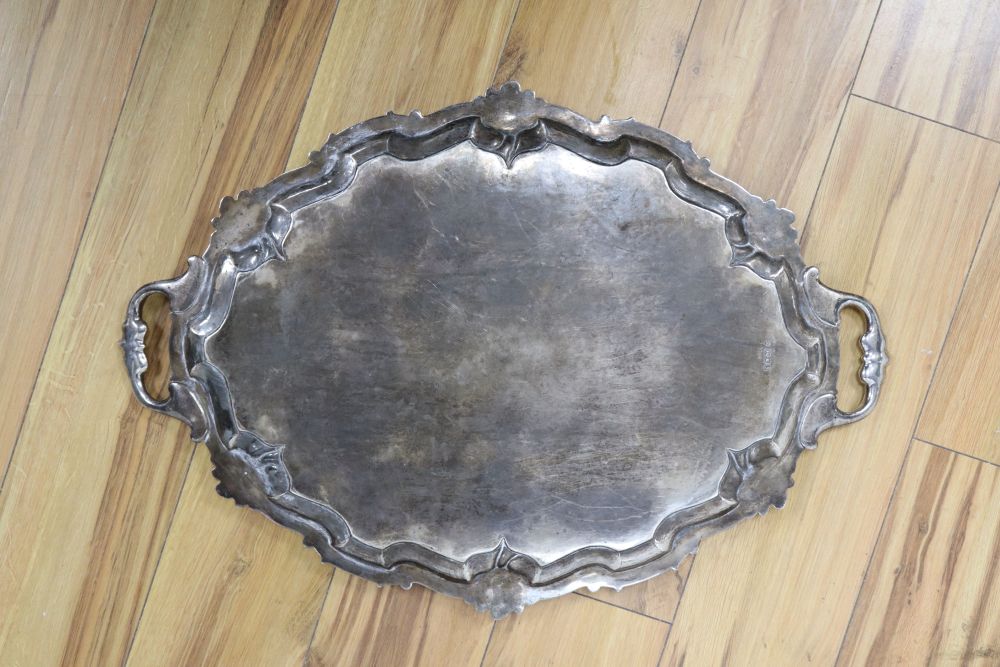 A large shaped oval silver two-handled tray with shell and scroll border, approx 116oz